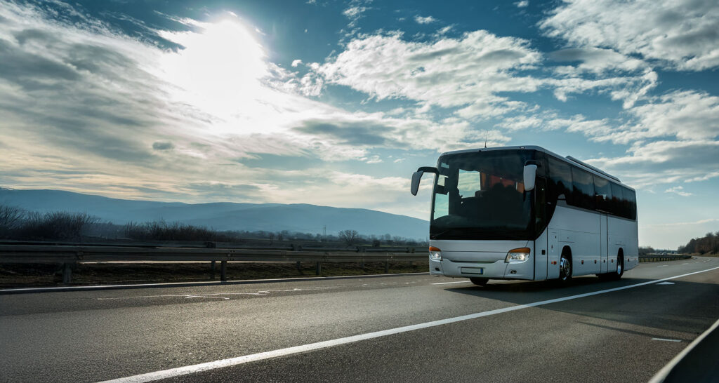 white coach on road heading to London